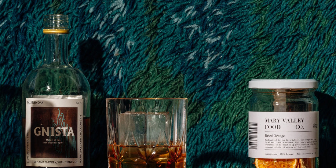 A glass of whiskey alternative drink with ice