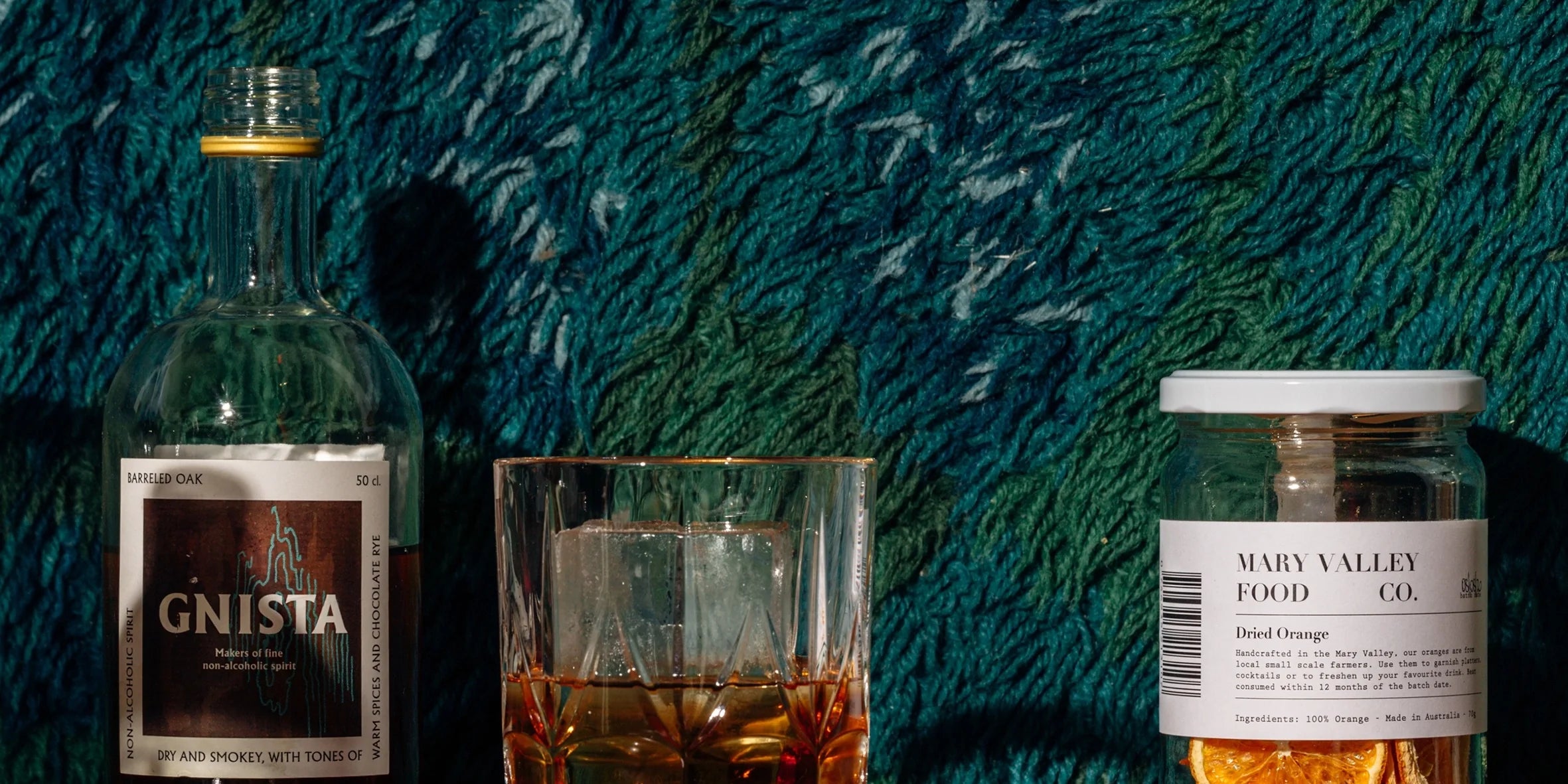 A glass of whiskey alternative drink with ice